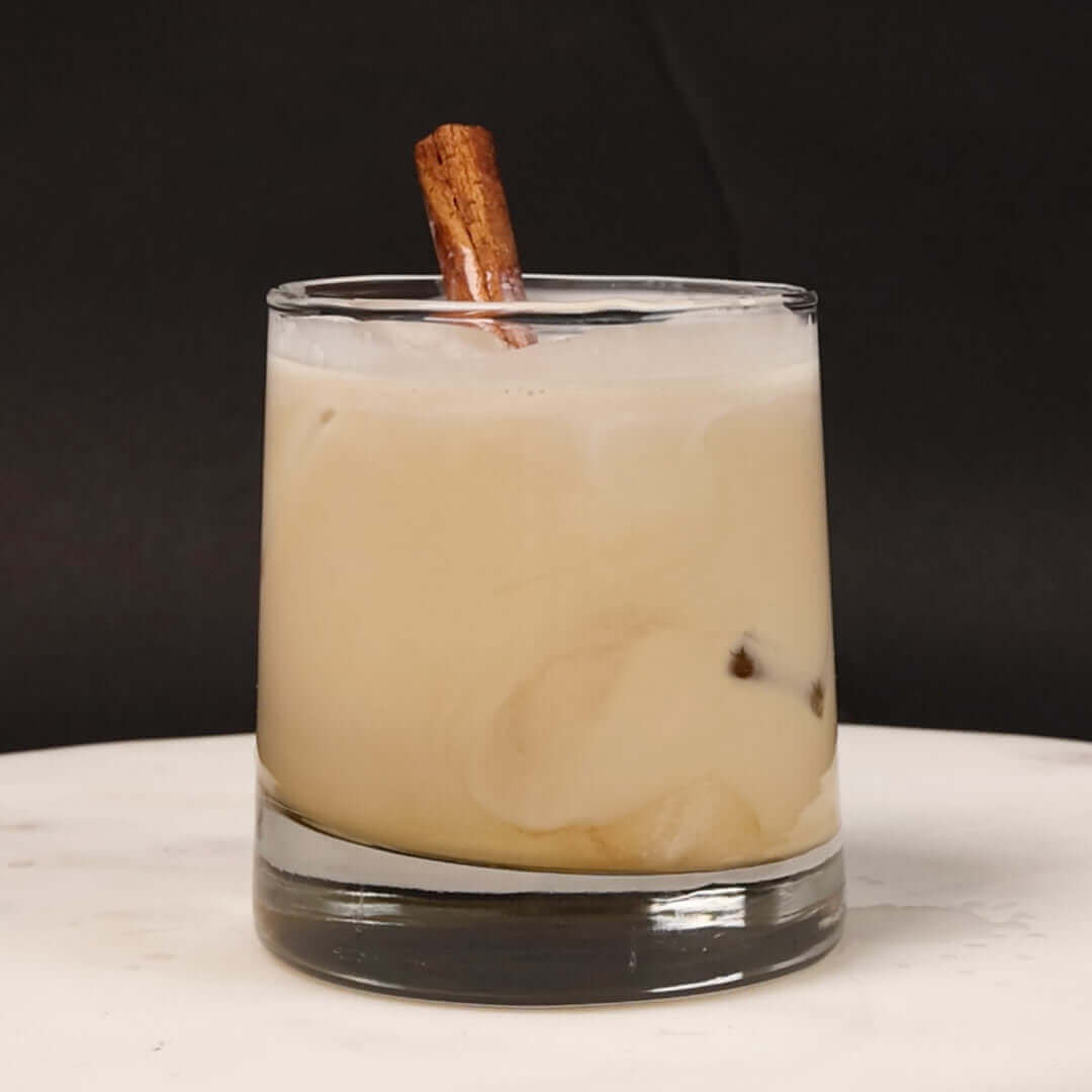 vanilla chai white russian with a cinnamon stick garnish