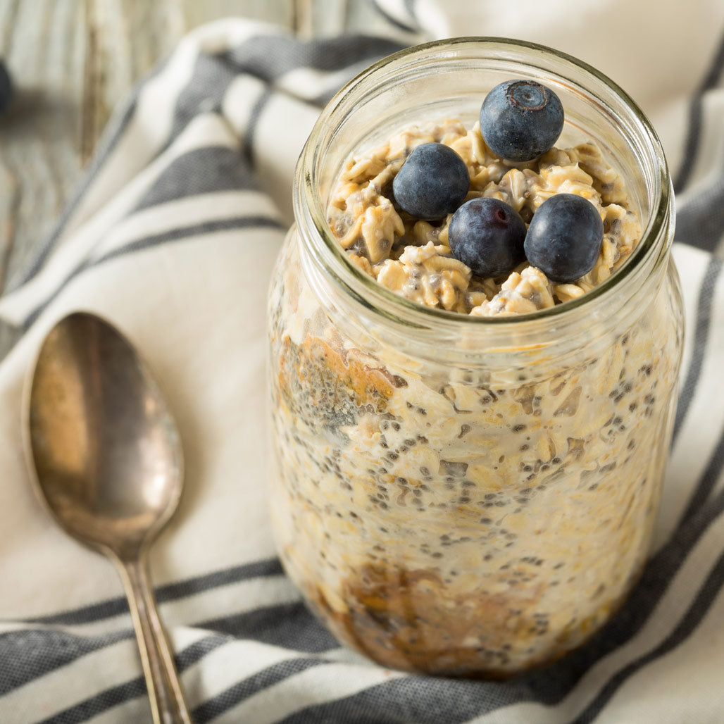 blueberry overnight oats in a jar topped with blueberries