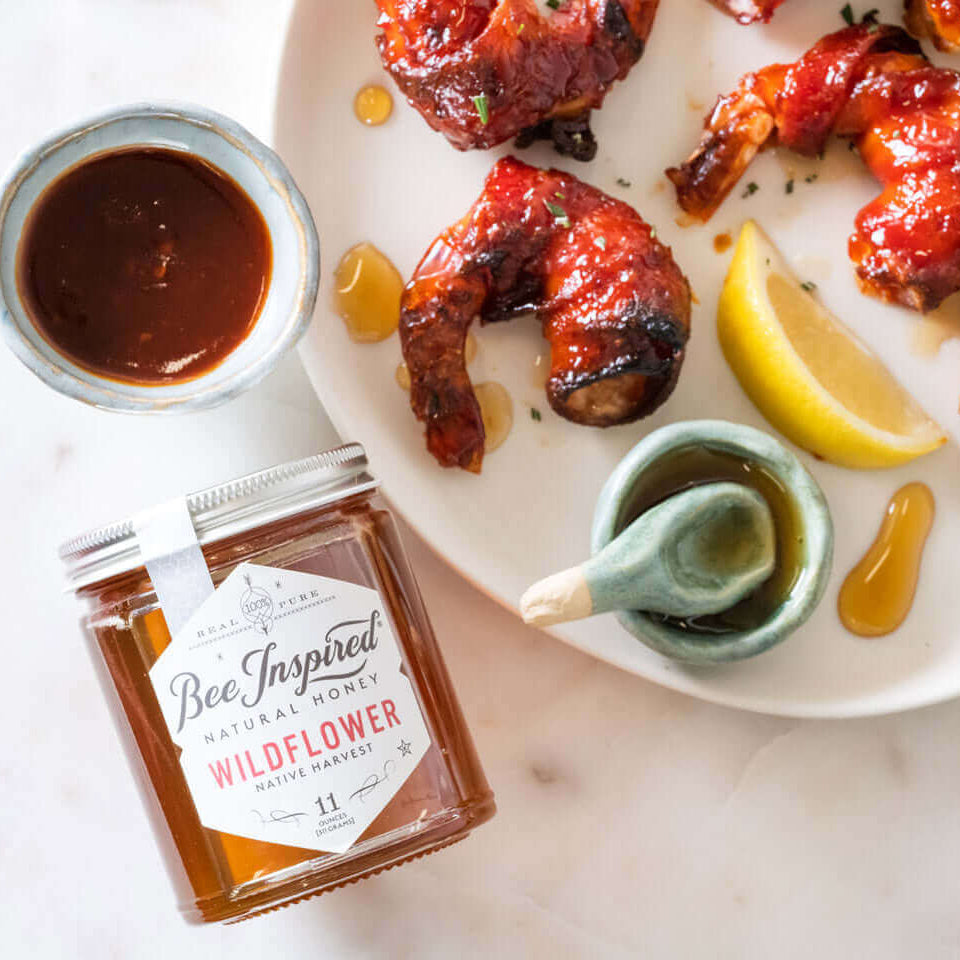 A platter of bacon wrapped shrimp drizzled in Wildflower honey by Bee Inspired Goods