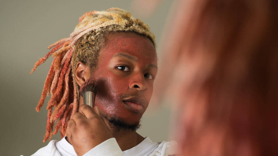 man applying Clarity face mask with a soft brush