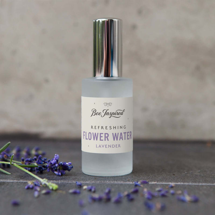 Bee Inspired lavender flower water next to fresh lavender buds 