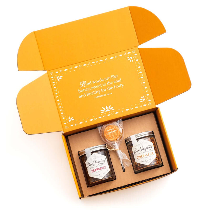 Gratitute gift with Cranberry honey, Cider + Spice tea, and a cinnamon lollipop in open box 