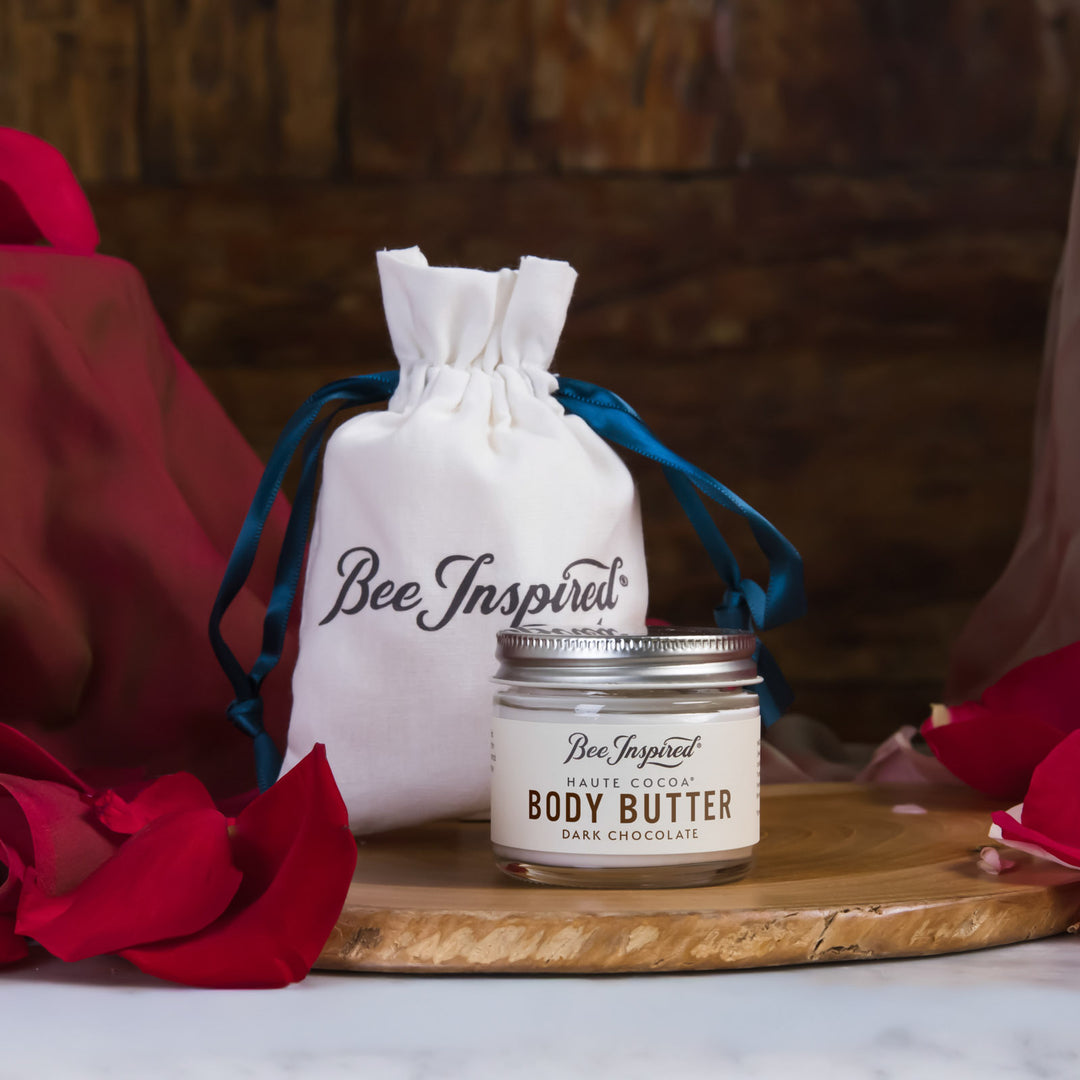Body butter jar with a drawstring bag labeled &