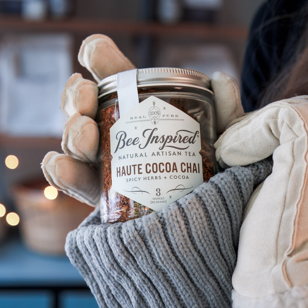 Jar of 'Bee Inspired' haute cocoa chai held by a person wearing gloves.