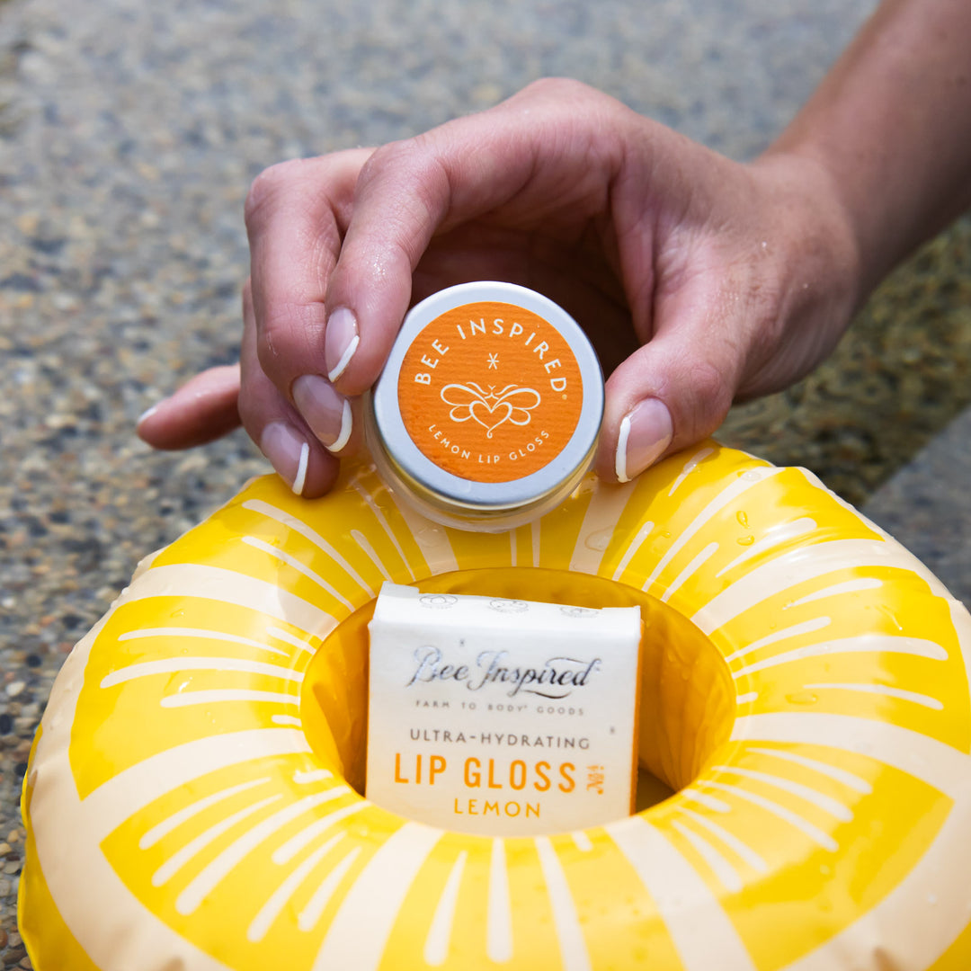 lemon lip gloss on a mini lemon slice inflatable in the pool