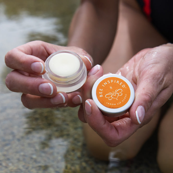 opening lemon lip gloss in the pool