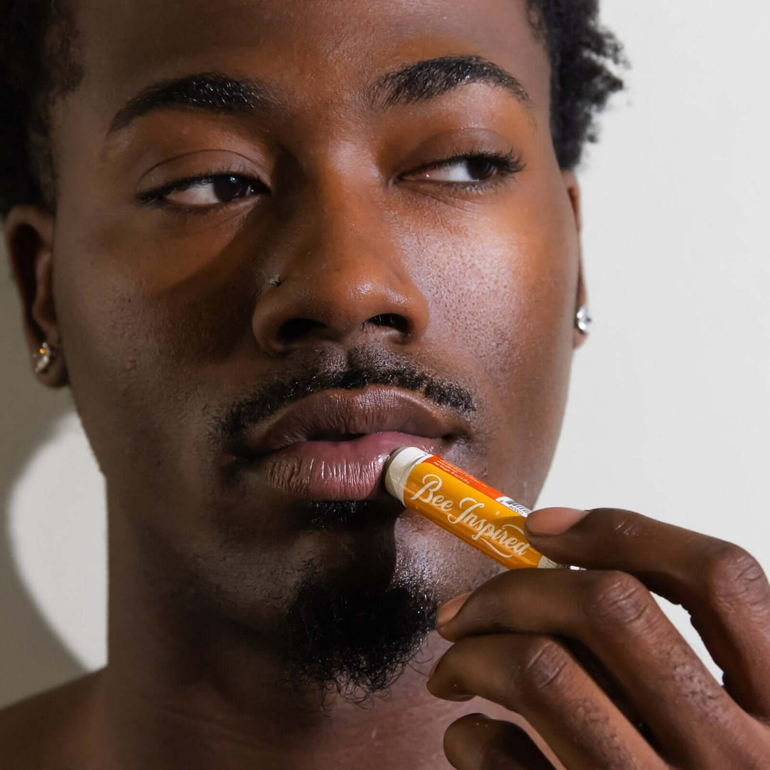 man applies Bee Inspired plastic-free lip balm