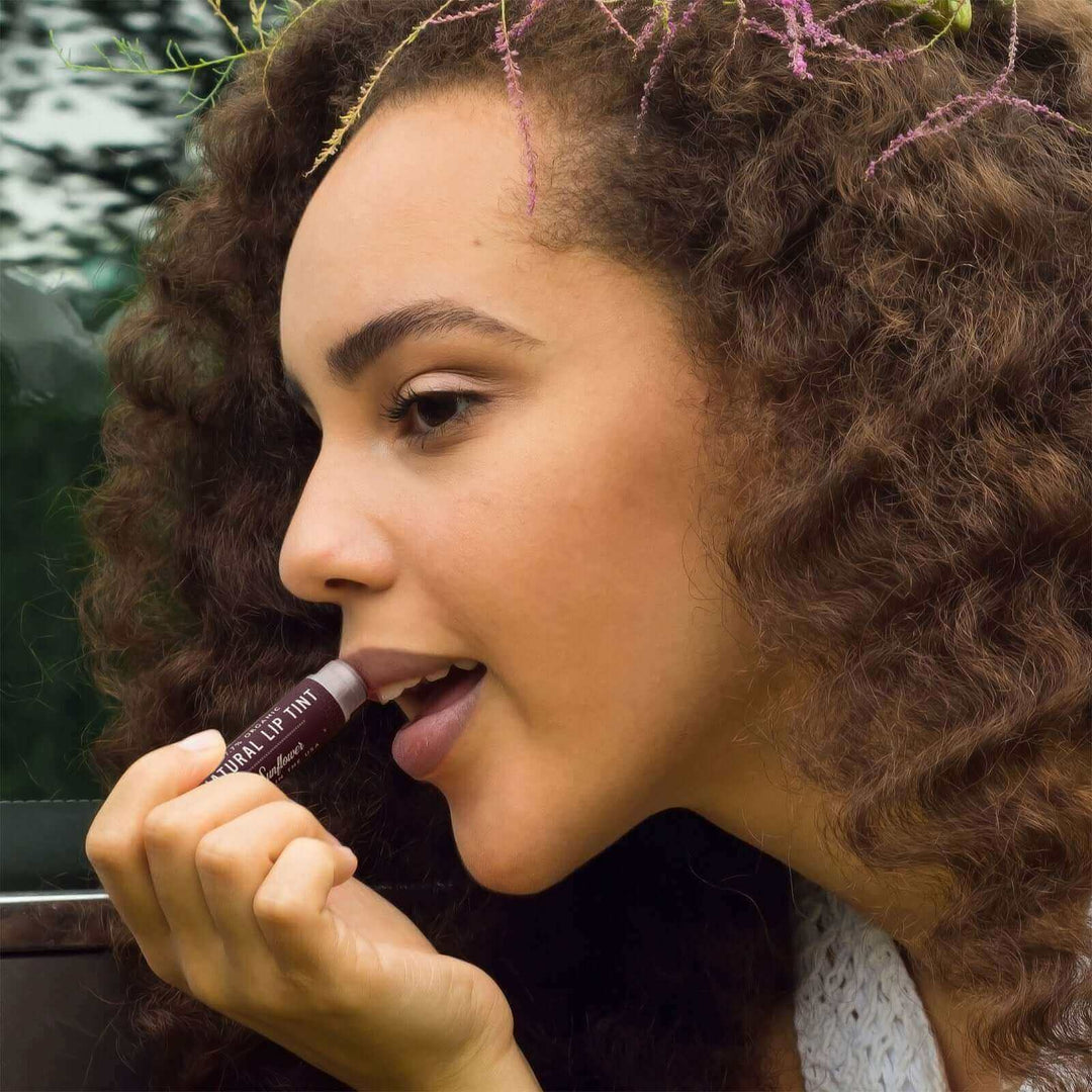 Woman applies Sunflower lip tint 