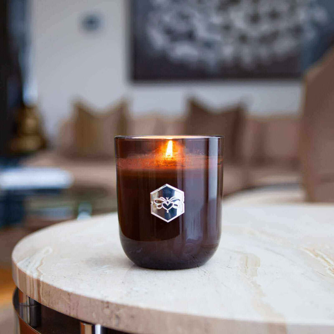 Luxe candle burning on living room table 