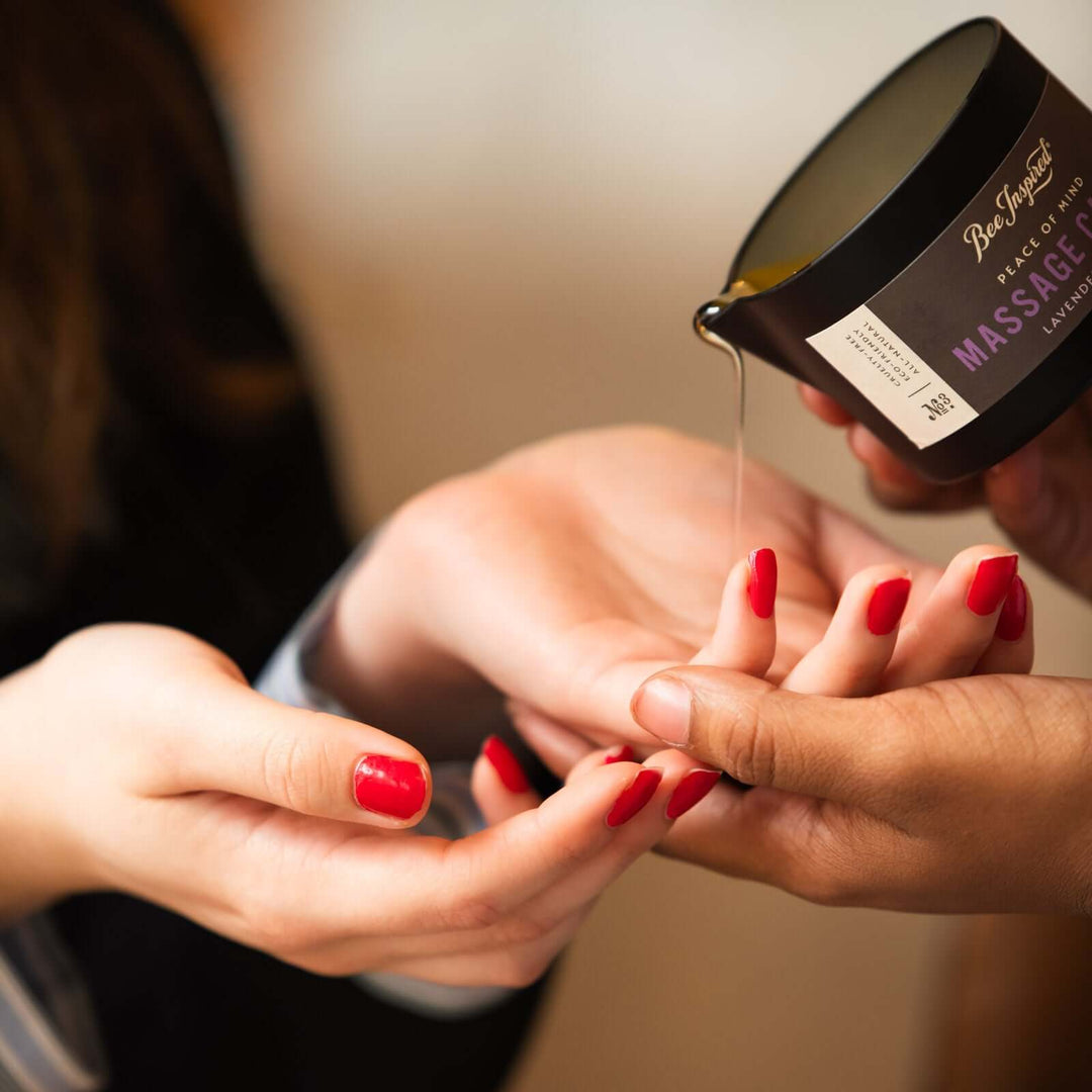 Peace of Mind massage candle oil poured onto a woman's hands 