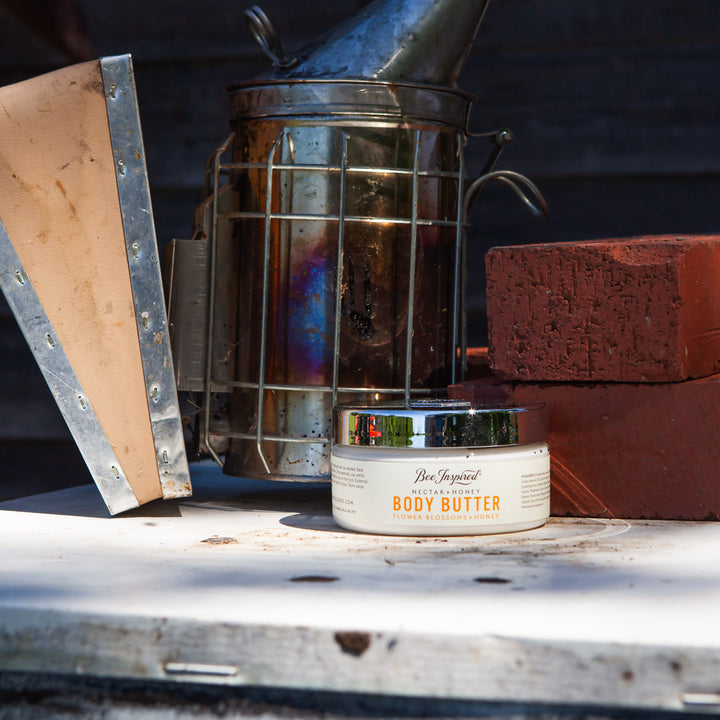 Nectar + Honey Body Butter next to beekeeping equipment