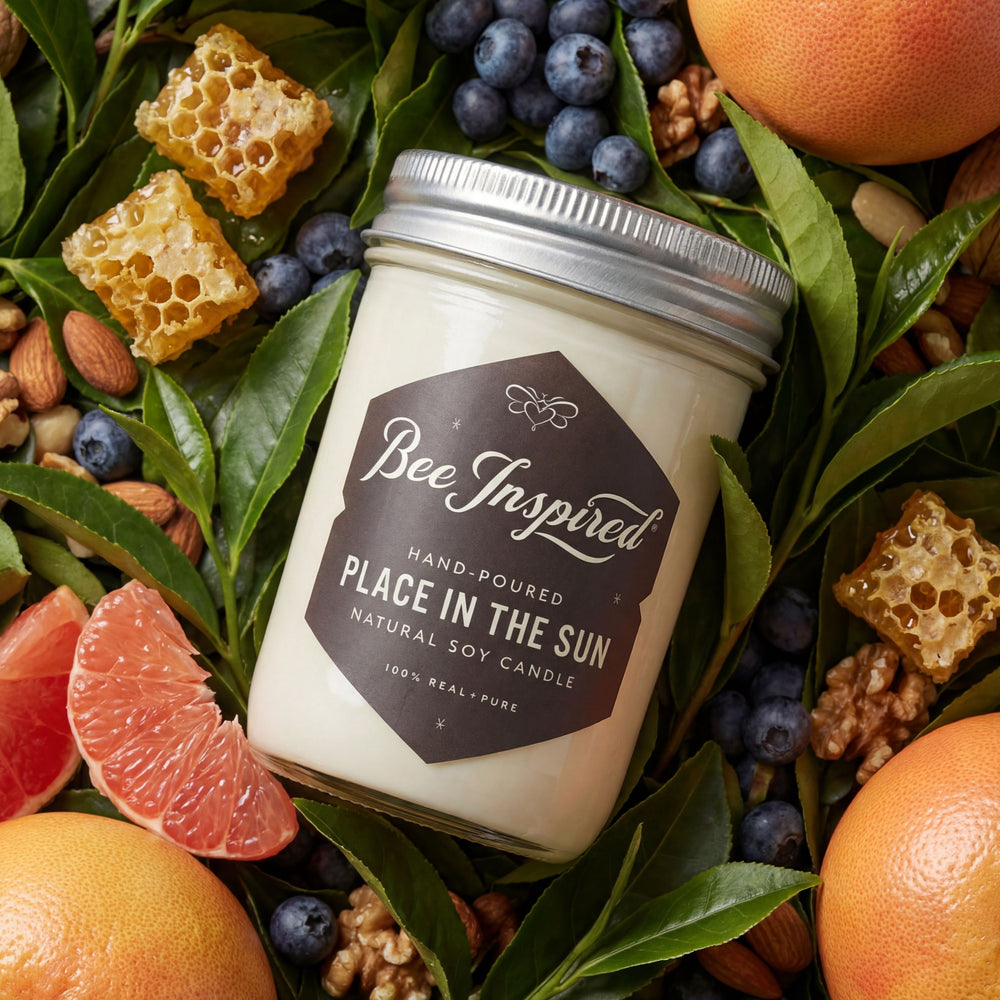 Bee-Inspired candle surrounded by fruits, nuts, and honeycomb on a leafy background