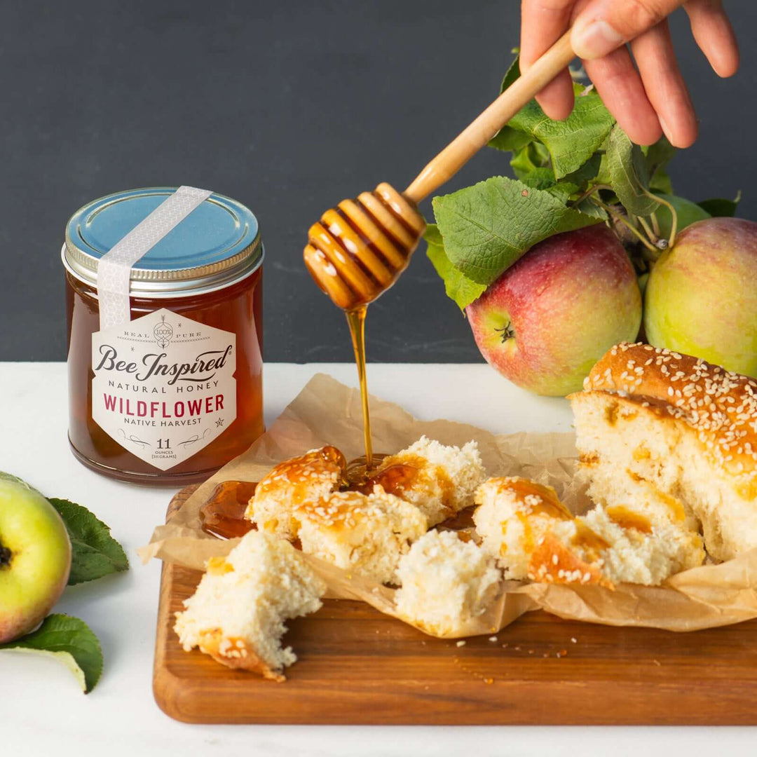 pouring wildflower honey over bread for rosh hashanah
