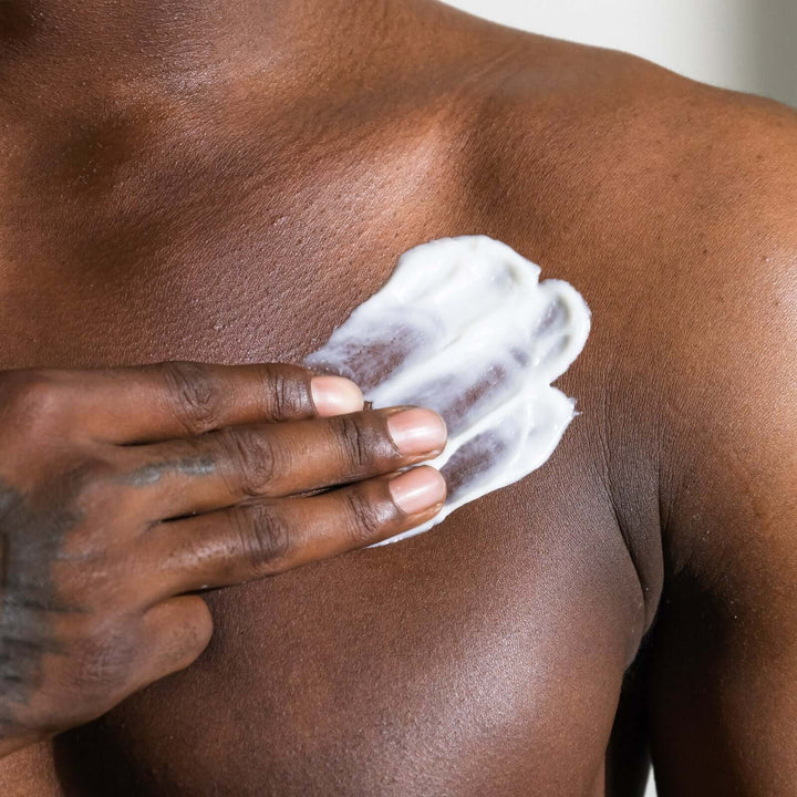 man applies Sea+Tea body cream on his chest