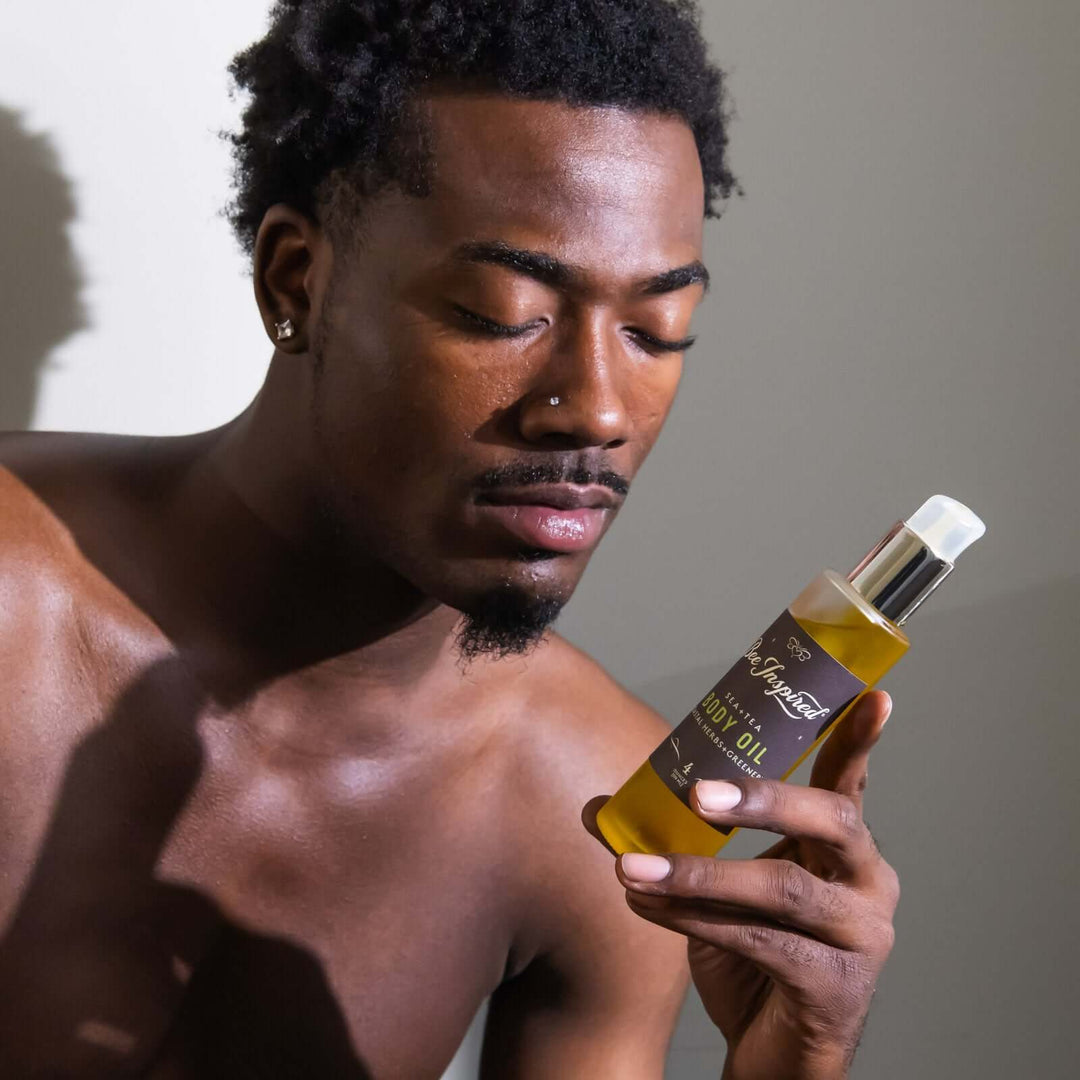 man reads the ingredient label of Sea+Tea body oil