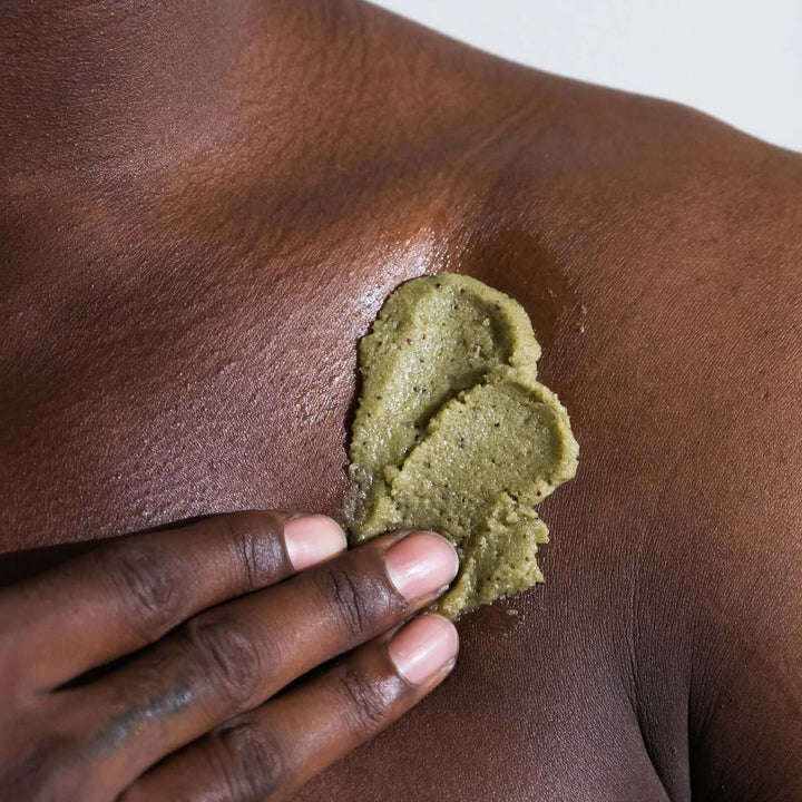 man applies Sea+Tea body scrub to his shoulder