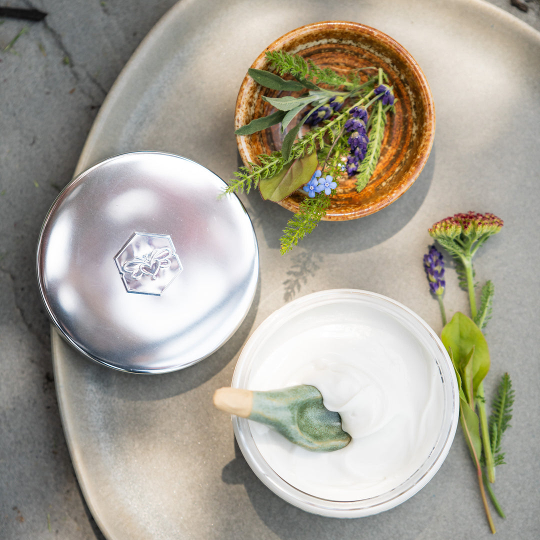 sea + tea body cream next to flowers
