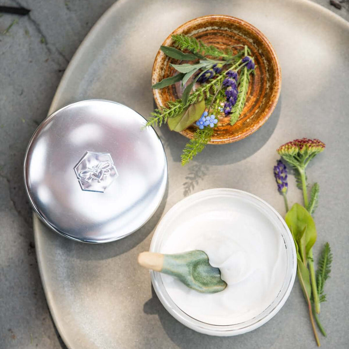 sea+tea cream from bee inspired honey retail store in owings mills on a plate with a small bowl full of greenery