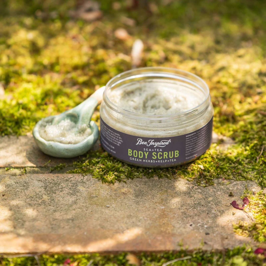 sea+tea scrub from bee inspired honey retail store in owings mills on the grass with a small bowl filled with scrub
