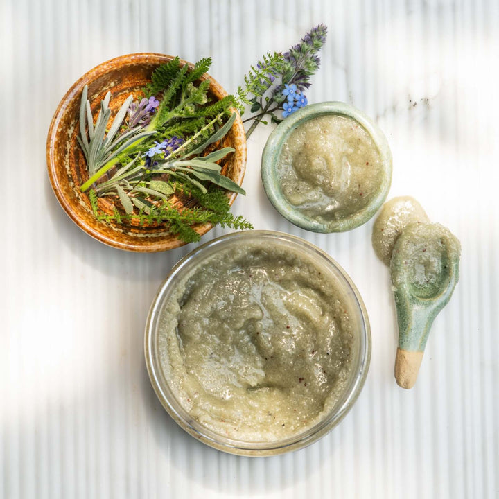 sea+tea scrub next to a small bowl filled with scrub and another small bowl filled with greenery