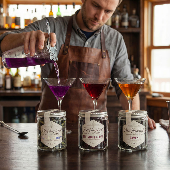 Barista pouring a purple liquid into a glass with jars labeled &