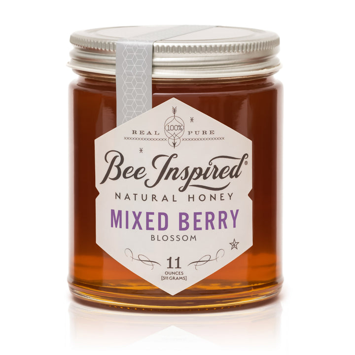 Jar of Bee Inspired Mixed Berry Blossom honey on a white background