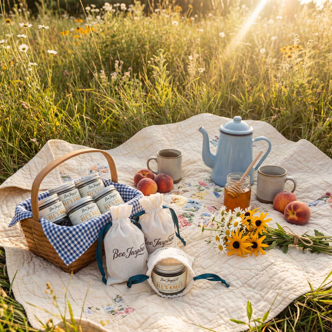 Picnic setup with Bee Inspired products on a blanket in a field