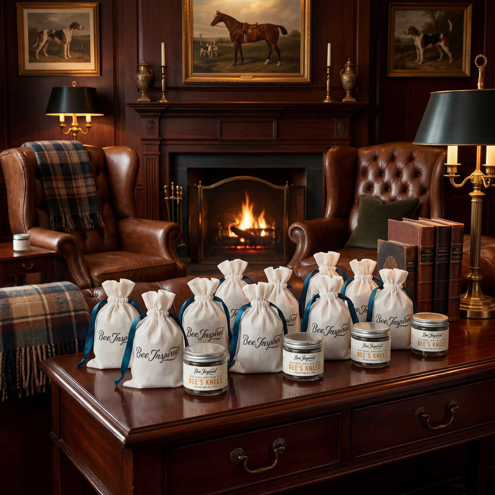 Beverage bags and jars on a wooden table with a fireplace and chairs in the background