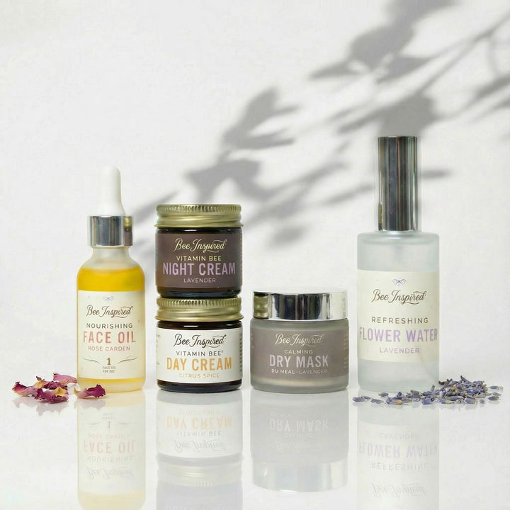 Collection of skincare products with labels on a reflective surface