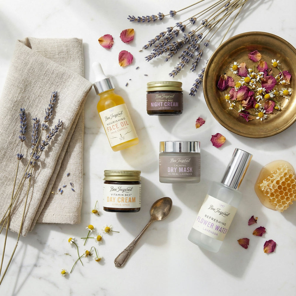 Bee Inspired Best Face Forward skincare products with lavender and flowers on a marble surface

