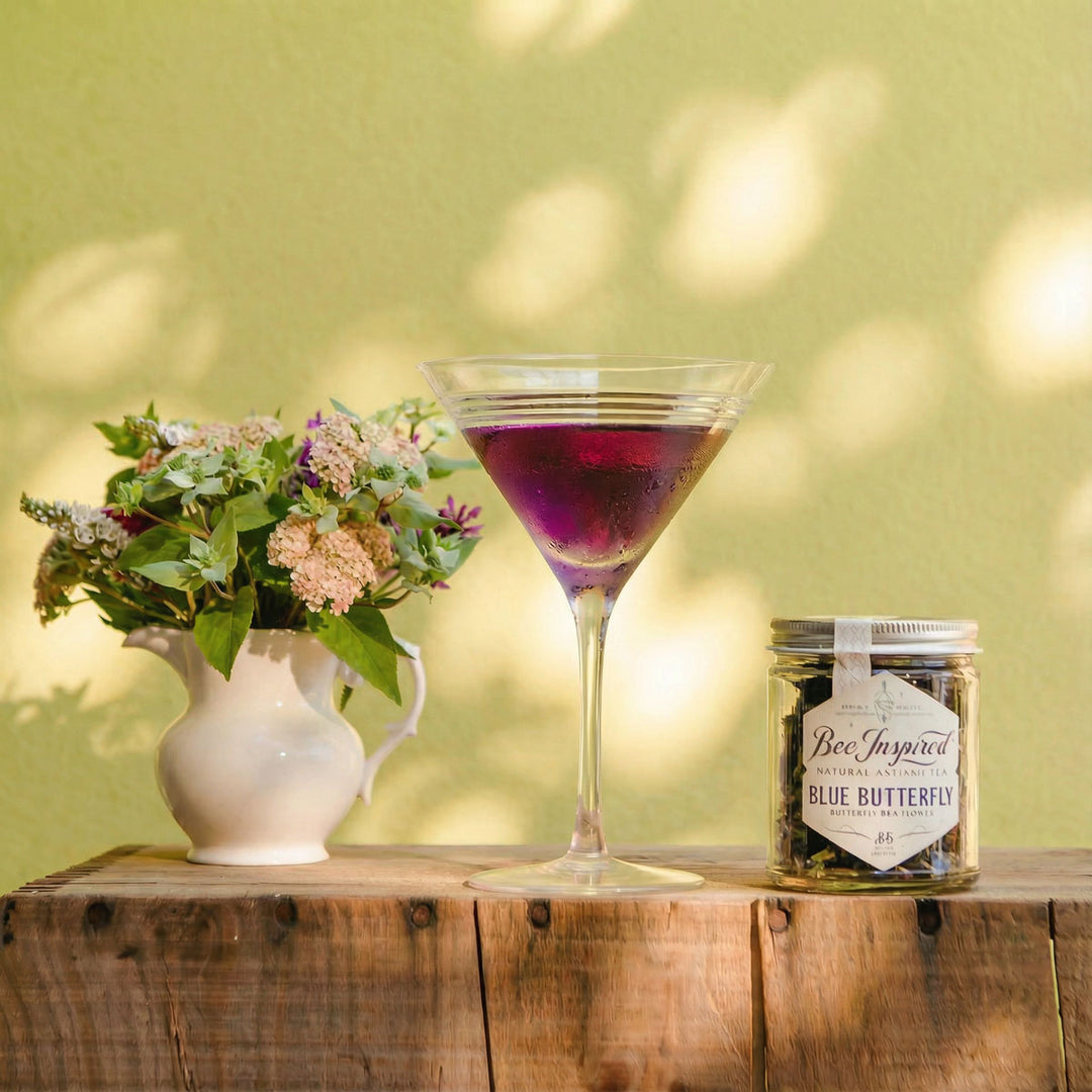 Purple cocktail in a martini glass with a jar of &