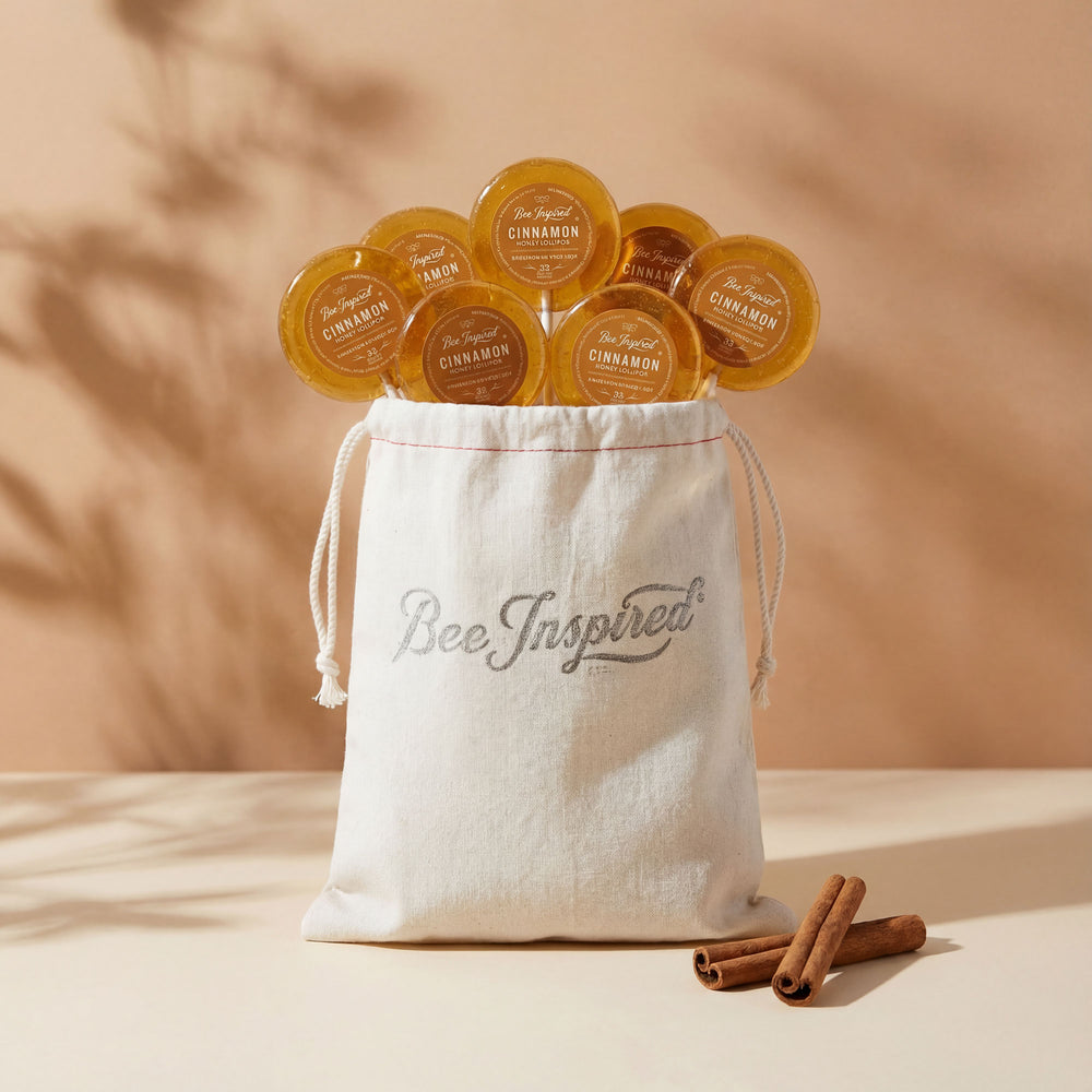 Bee Inspired product packaging with candles and a drawstring bag on a beige background