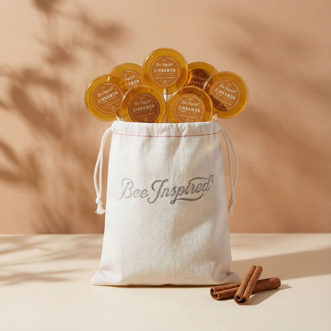 Bee Inspired product packaging with candles and a drawstring bag on a beige background