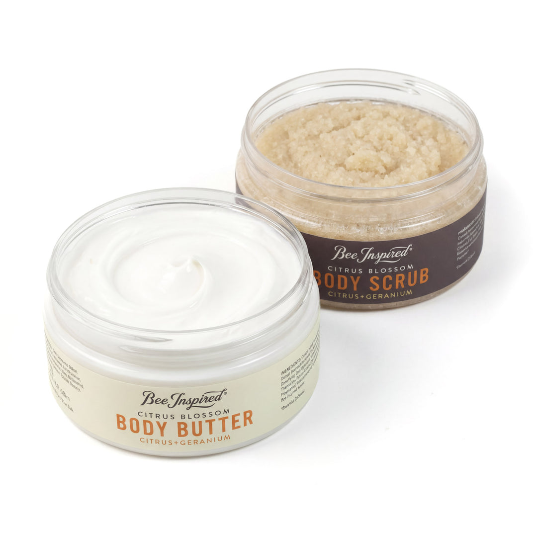 Two jars of Bee Inspired body butter and scrub on a white background
