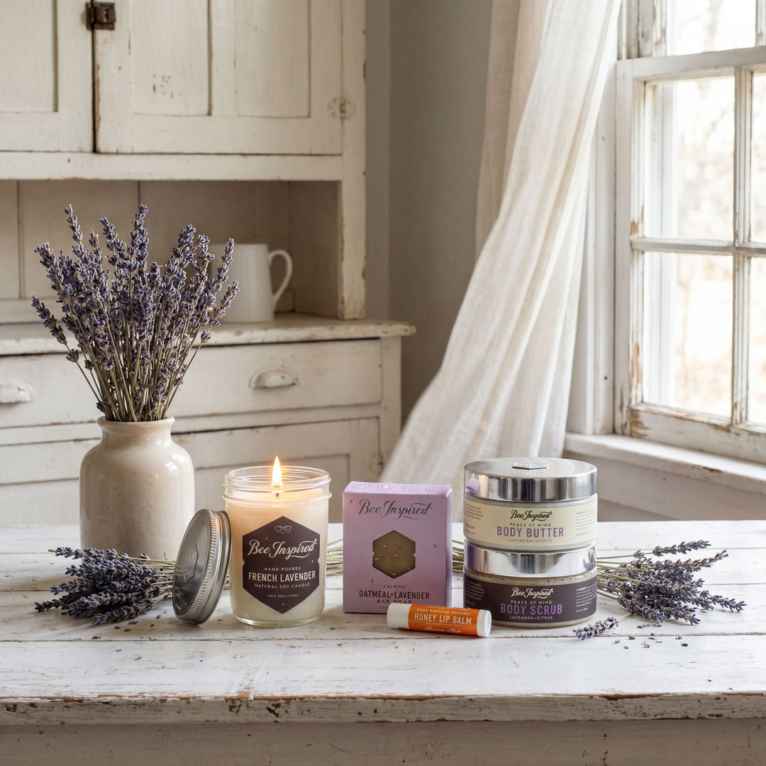 Lavender products including a candle, jar, and bottles on a wooden surface with a window in the background.