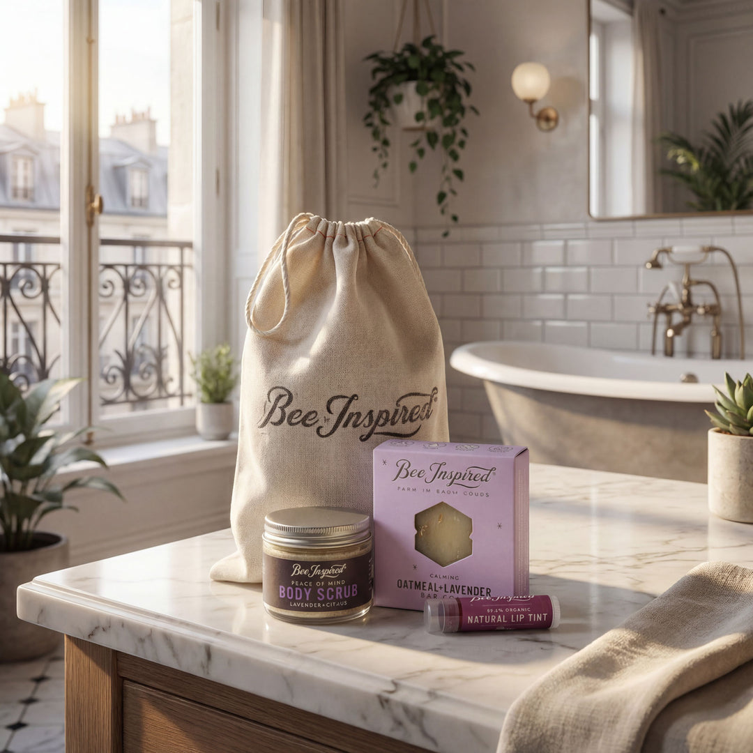 Bathroom counter with 'Bee Inspired' products including a drawstring bag, jar, box, and tube.