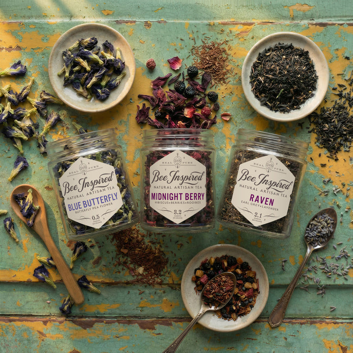 Assorted dried tea leaves and packaging on a rustic wooden surface with &