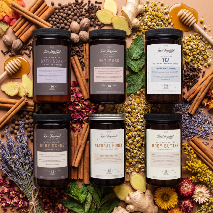 Collection of natural skincare products with herbs and spices on a wooden surface