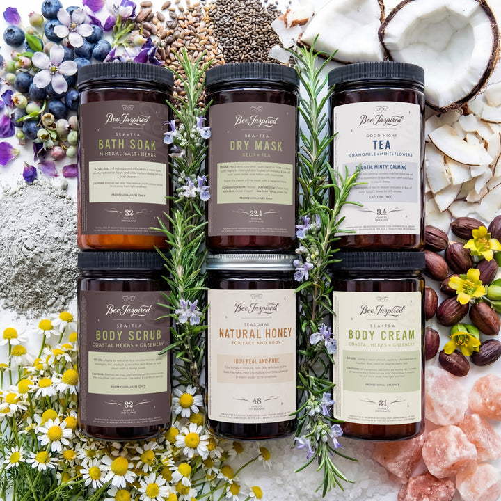 Collection of natural skincare products with herbs and flowers on a textured surface