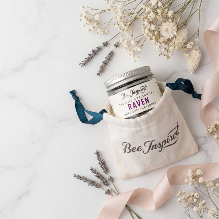 Jar of tea with a decorative bag labeled &