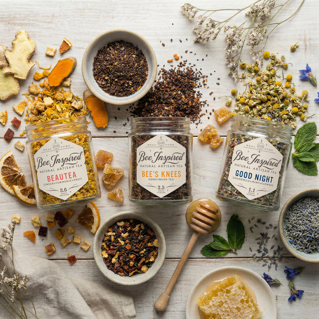 Assorted herbal teas and ingredients on a wooden surface with &