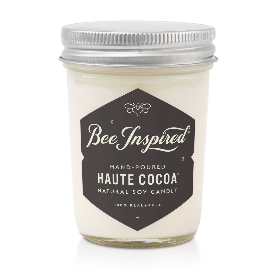 Candle jar labeled 'Bee Inspired' with 'Haute Cocoa' flavor on a white background