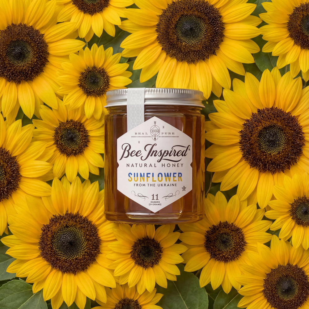 Jar of Bee Inspired honey surrounded by sunflowers