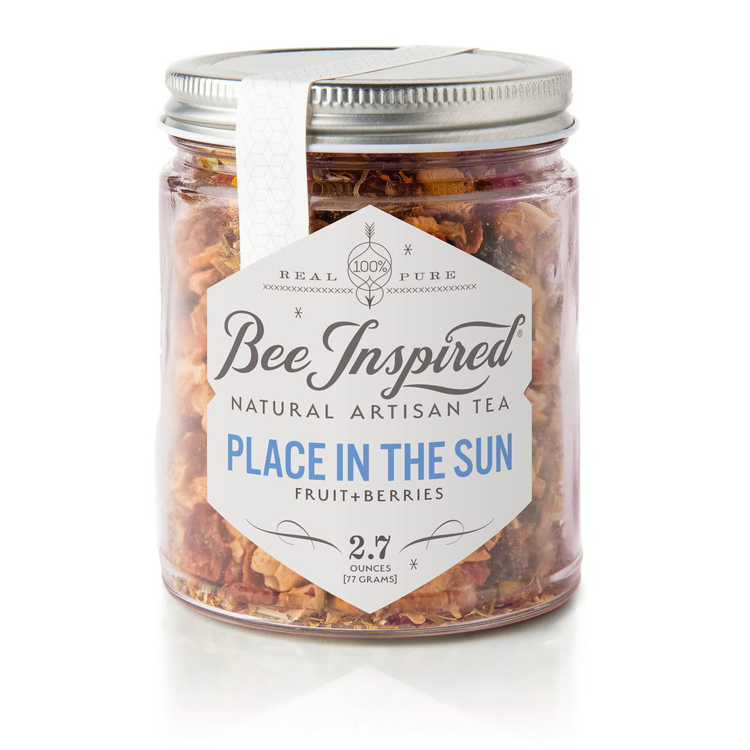Jar of Bee Inspired Place in the Sun Fruit Tea with a white label on a white background